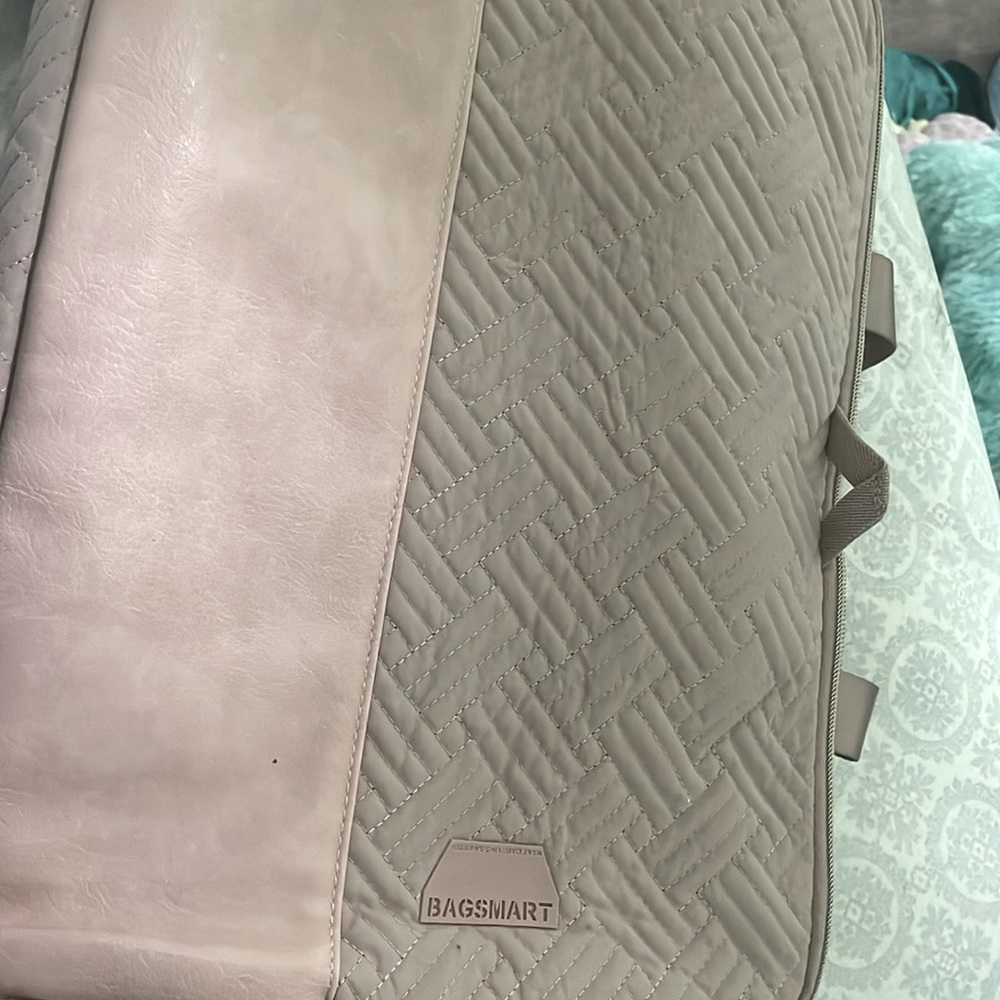 A baby pink computer bag with RFDI safe protection and digi protection